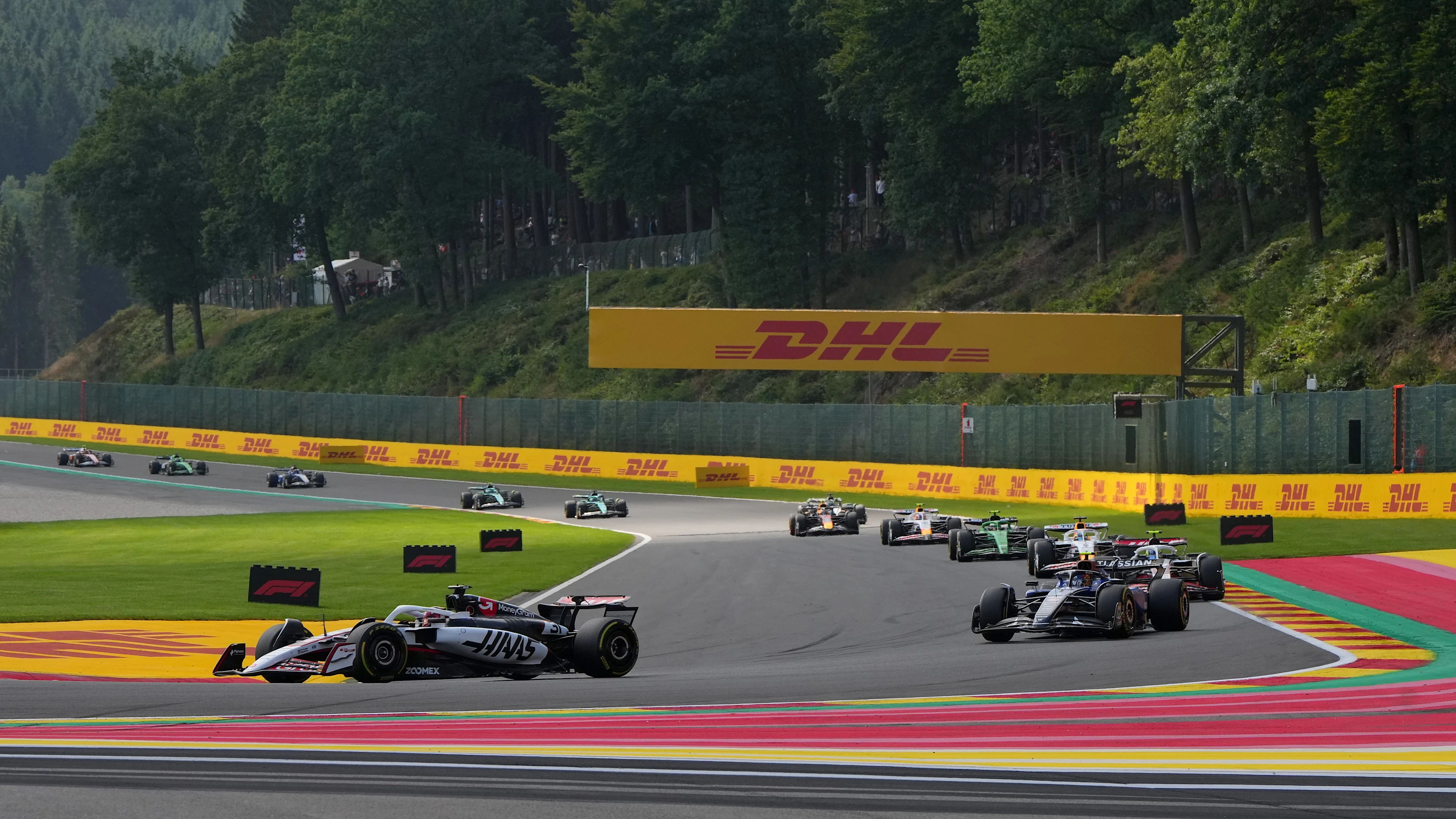 SPA, BELGIUM - JULY 26: Esteban Ocon of France driving the (31) Haas F1 VF-25 Ferrari leads Carlos