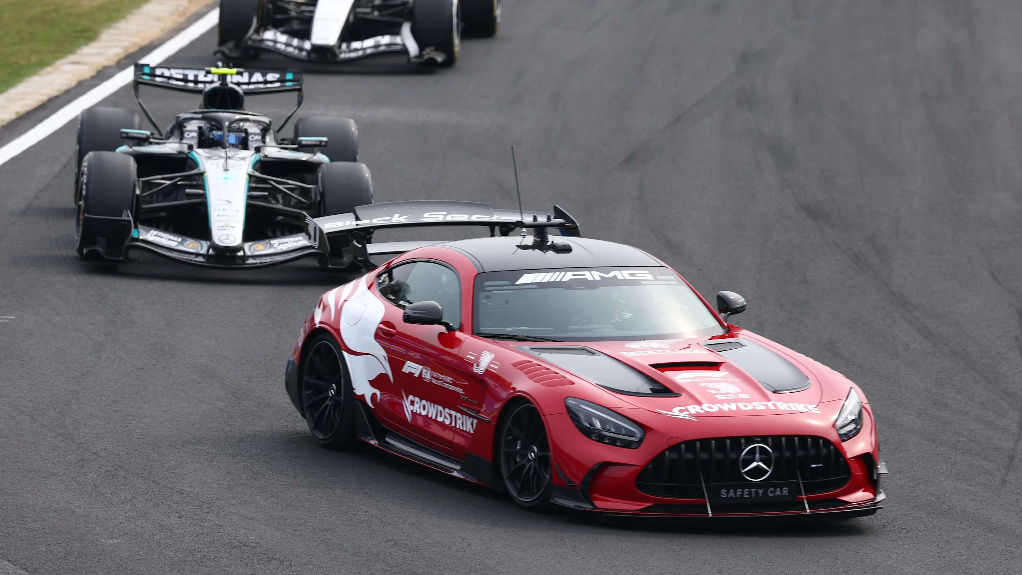 SUZUKA, JAPAN - MARCH 29: The FIA Safety Car leads Andrea Kimi Antonelli of Italy driving the (12)