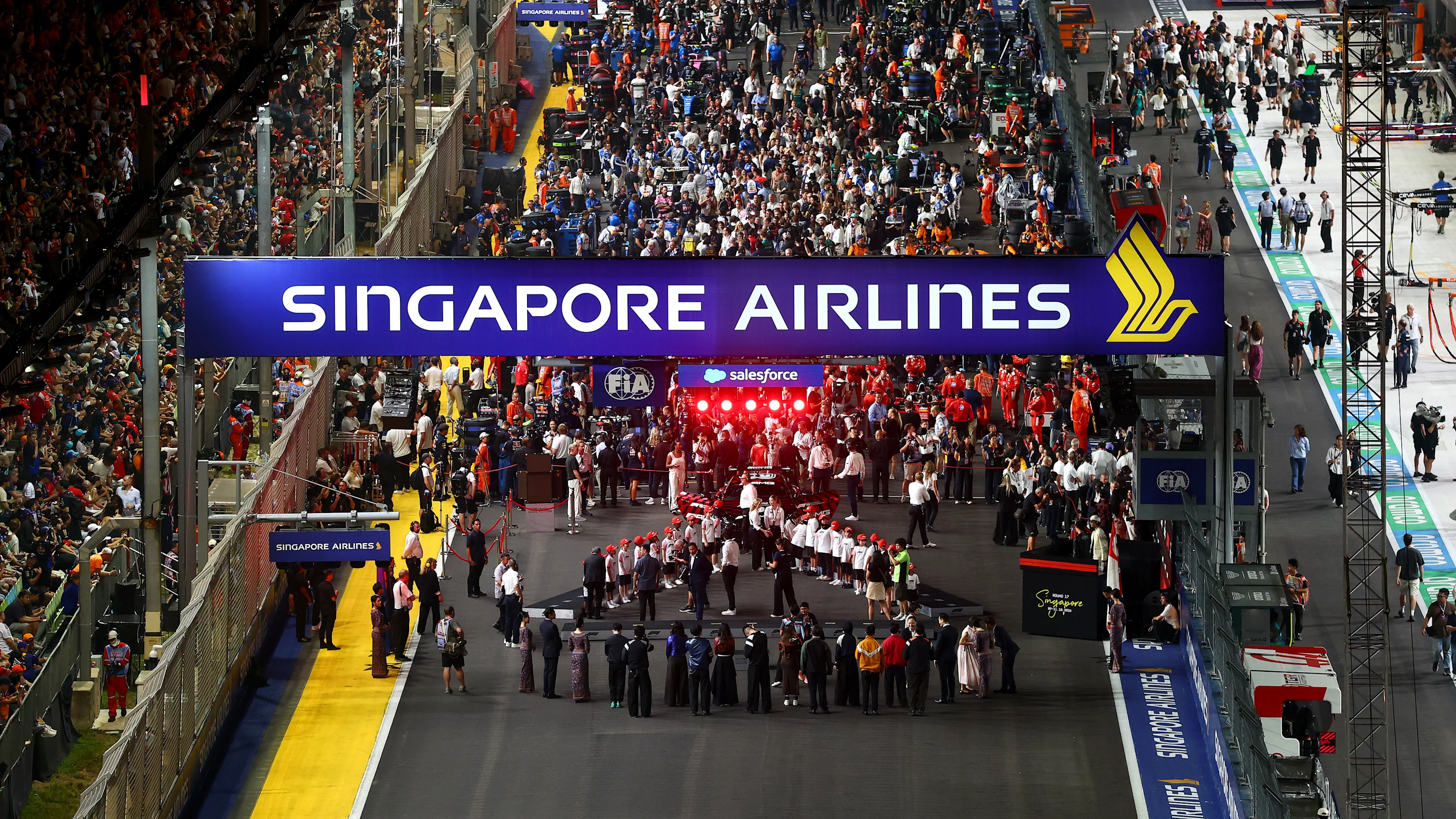 SINGAPORE, SINGAPORE - OCTOBER 11: Grid kids are lined up for the national anthem prior to the F1