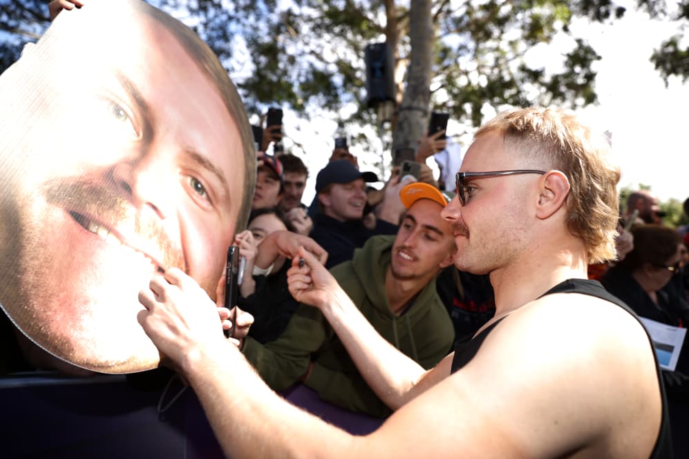 MELBOURNE, AUSTRALIA - MARCH 30: Valtteri Bottas of Finland and Alfa Romeo F1 greets fans at the
