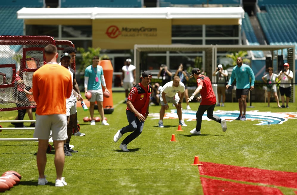 MIAMI, FLORIDA - MAY 04: Carlos Sainz of Spain and Ferrari is put through his paces by players from