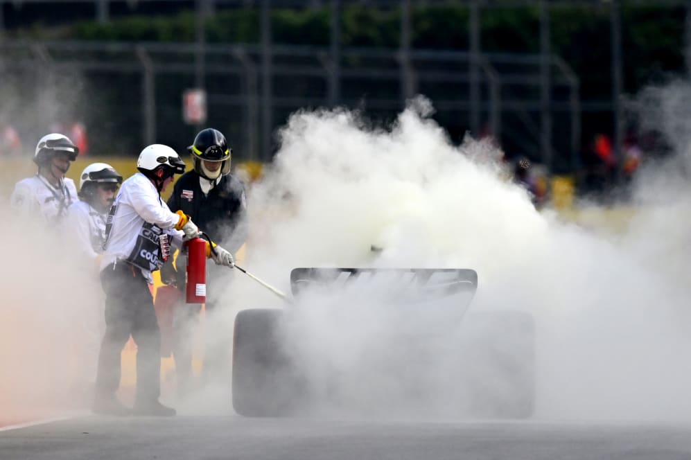 MONTREAL, QUEBEC - JUNE 16: Track marshals use fire extinguishers on the car of Nico Hulkenberg of