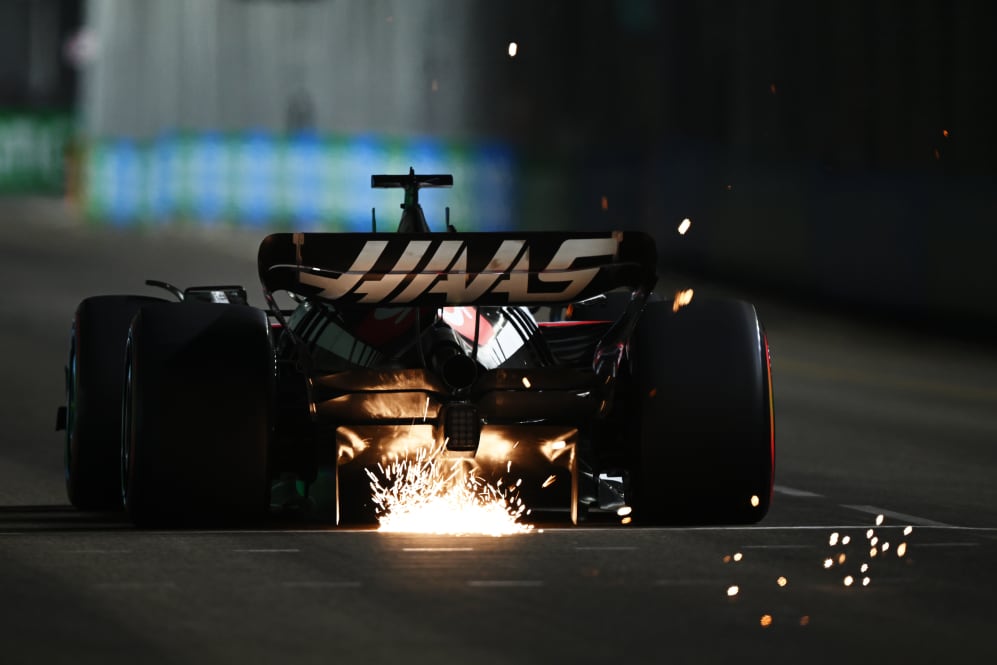 SINGAPORE, SINGAPORE - SEPTEMBER 16: Sparks fly behind the car of Kevin Magnussen of Denmark