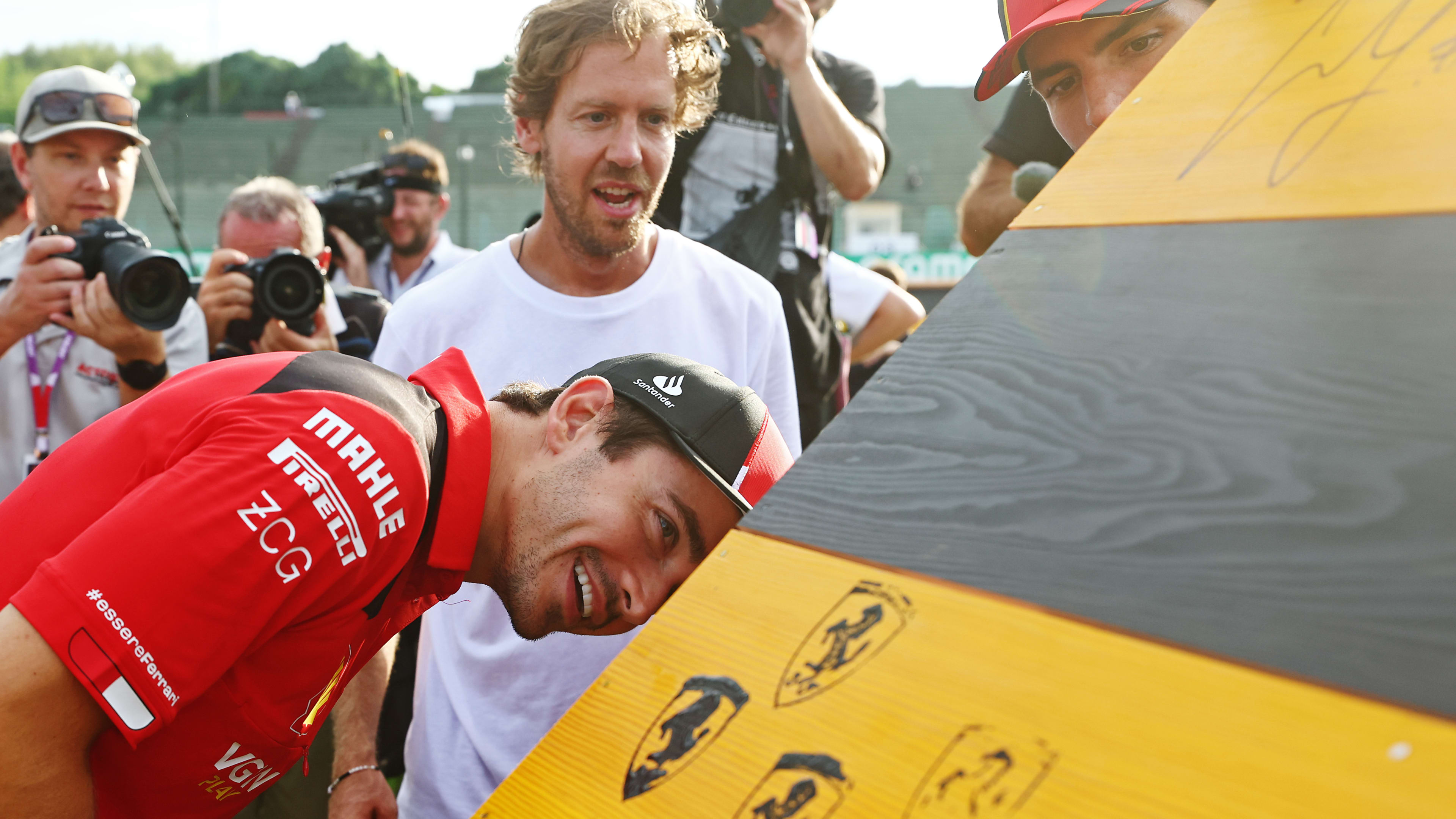SUZUKA, JAPAN - SEPTEMBER 21: Charles Leclerc of Monaco and Ferrari and Sebastian Vettel talk at