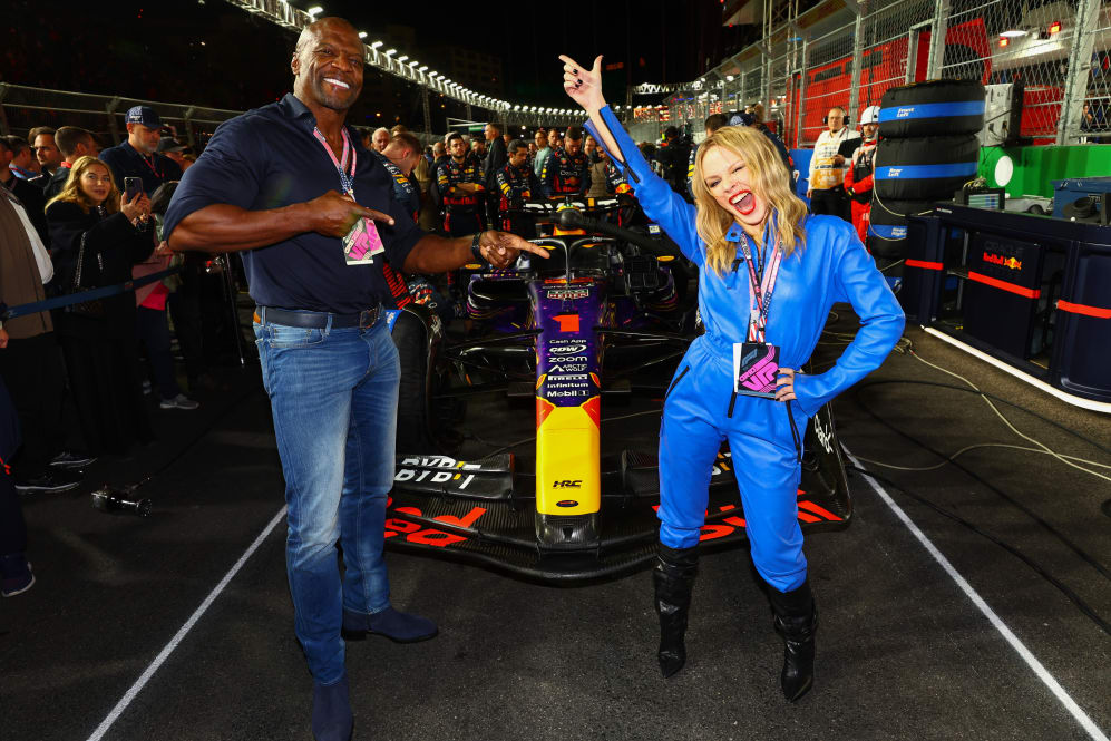 LAS VEGAS, NEVADA - NOVEMBER 18: Terry Crews and Kylie Minogue poses for a photo on the grid prior